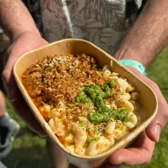 A person holding a bowl with food